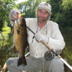 Tim with smallie on the fly rod 